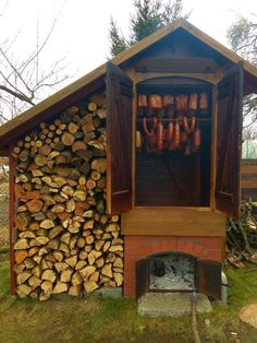 a firewood shed with logs stacked in it