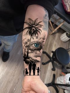 a person with a tattoo on their arm that has an eye in the palm tree