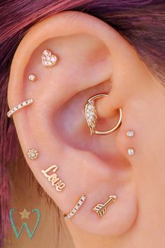 an ear with three different types of piercings on it