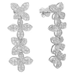 Discover the epitome of elegance with our 2.00 Carat Flower Diamond Drop Earrings in exquisite 18K White Gold, featuring a graceful arrangement of four intricately crafted flowers. Adorned with a total of 2.00 carats of brilliant diamonds, these earrings captivate with their radiant sparkle and timeless beauty. The delicate design, suspended in luminous white gold, adds a touch of sophistication to any ensemble, making these earrings perfect for both special occasions and everyday glamour. Metic Luxury White Platinum Cluster Earrings, Luxury White Gold Cluster Earrings In Flower Shape, Fancy Design, Flower Drop Earrings, Long Drop Earrings, Diamond Flower, Diamond Drops, Diamond Drop Earrings, Floral Earrings