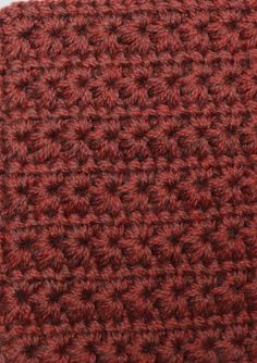 a close up view of a red crochet dishcloth