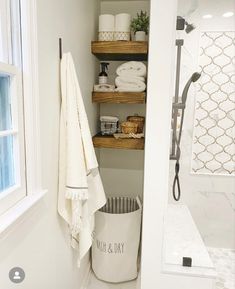 a bathroom with shelving and towels in it