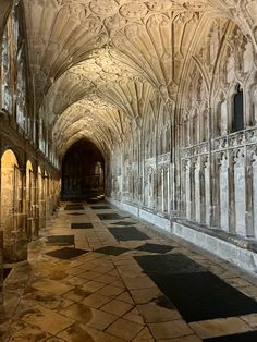 the inside of an old building with stone flooring and arches on either side of it