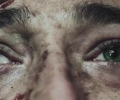 a man's eyes are covered in dirt