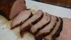 sliced meat sitting on top of a cutting board