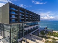 an apartment building overlooking the ocean on a sunny day