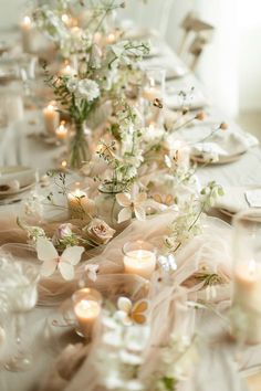 the table is set with candles and flowers