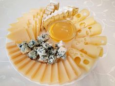 an assortment of cheeses and crackers on a plate