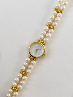 Beautiful Luminess gold watch with white pearl band. This watch is in very good condition, no scratches on dial or band. Please review pictures for additional details. Needs battery. Brand: Luminess  Condition: Pre-owned, Great Condition  Measurements: Length: 6.5 inches Face: 0.75 inch x 0.75 inches Pearl Watch, Girly Jewelry, Women Wrist Watch, Women's Watch, Wren, Wrist Watches, Jewelry Necklace, White Pearl, Minimalist Jewelry