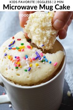 a cupcake with sprinkles is being dunked into the coffee mug