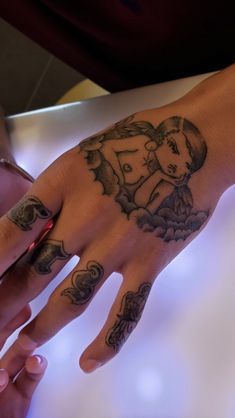 a woman's hand with a tattoo on it