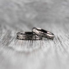 two wedding bands sitting on top of each other