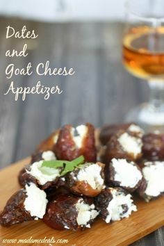 dates and goat cheese appetizer on a cutting board next to a glass of wine