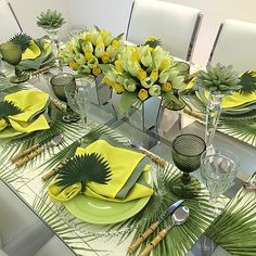 the table is set with yellow and green place settings