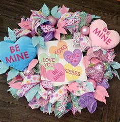 valentine's day wreath made out of hearts and ribbons with be mine written on it