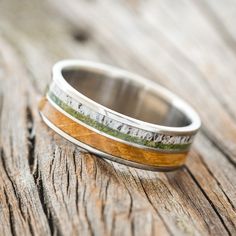 a wooden and metal ring sitting on top of a wooden table