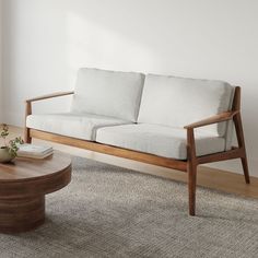 a white couch sitting on top of a wooden table