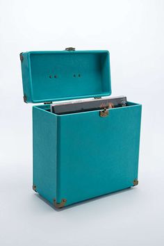 an open blue suitcase sitting on top of a white floor next to a google search box