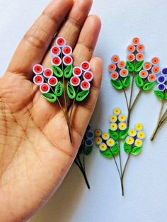 two handmade flowers sitting next to each other