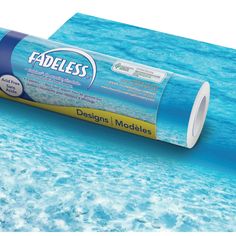 a roll of adhesive sitting on top of the ocean floor next to some water