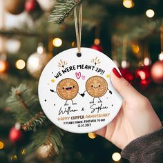 a christmas ornament that says we were meant to be with two cookies on it