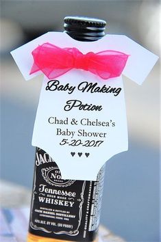 a baby shower bottle with a red bow on it's neck and label that says baby making problem chad & chelsea's baby shower