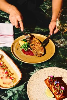 two plates with food on them, one being eaten and the other is holding a fork