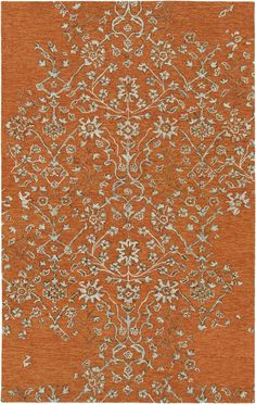 an orange rug with white and blue flowers on it