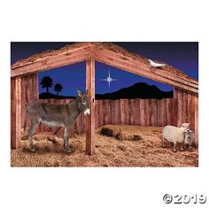 two donkeys and a sheep in a barn at night with a star above them