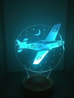 an airplane illuminated in the dark with stars