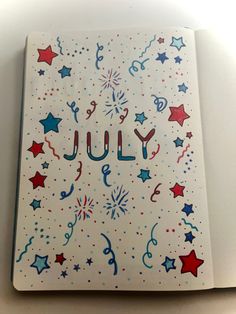 a notebook with the word july written in red, white and blue stars