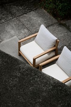 two chairs sitting next to each other on the ground