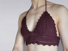 a woman wearing a crochet bra top with her hands on her hips