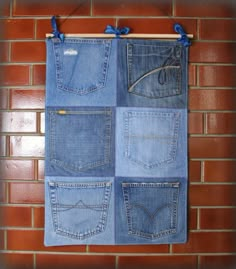 an old pair of jeans hanging on a brick wall