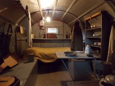 the inside of an airplane cabin with a bed and other items on the table in front of it