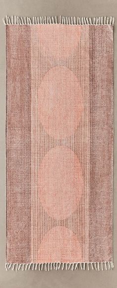 an orange and pink rug with fringes on it