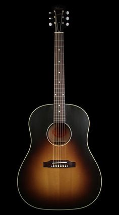 an acoustic guitar is shown against a black background, with the fret and strings visible