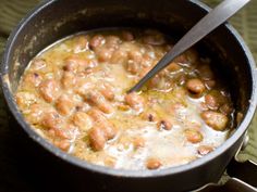 a pot filled with beans on top of a table