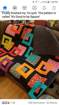 a couch with a colorful quilt on top of it