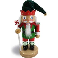 a wooden nutcracker holding a candy cane and wearing a green hat with red trim