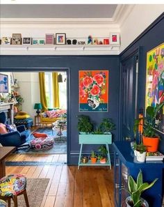 a living room filled with furniture and lots of plants