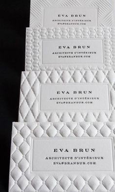 three white business cards on top of each other