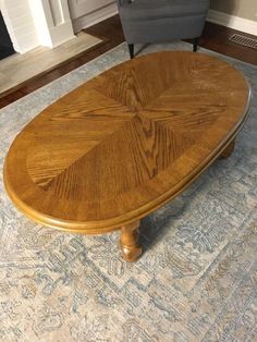 a wooden table sitting on top of a blue rug