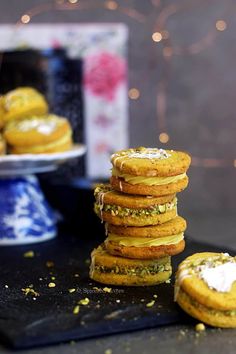 a stack of cookies sitting on top of a black tray next to a blue and white plate