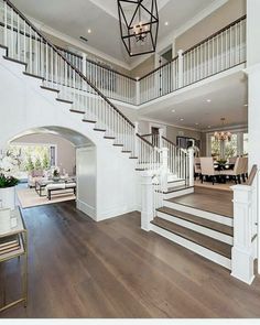 the inside of a house with stairs and hardwood floors