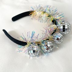 a close up of a headband with disco balls on it