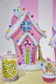 a pink gingerbread house with candy and candies