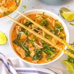 two bowls of chicken noodle soup with chopsticks