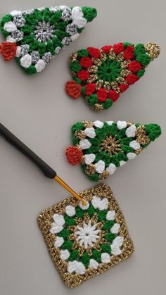 three crocheted ornaments are being worked on by an artist with a large brush