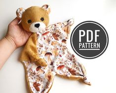 a hand holding a teddy bear on top of a piece of fabric with the words pdf pattern below it